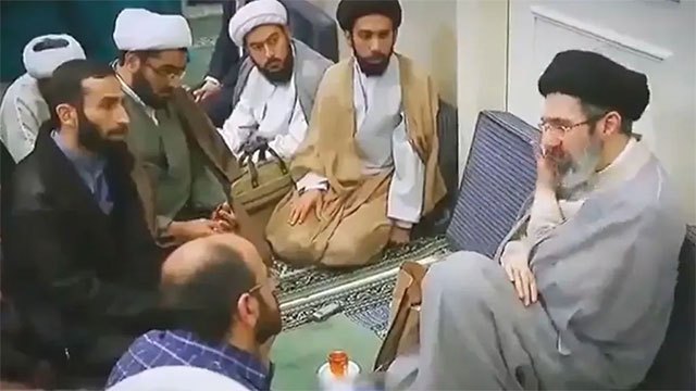 Footage shows Khamenei meeting an official, but covered windows and voice-only communication fuel ongoing speculation