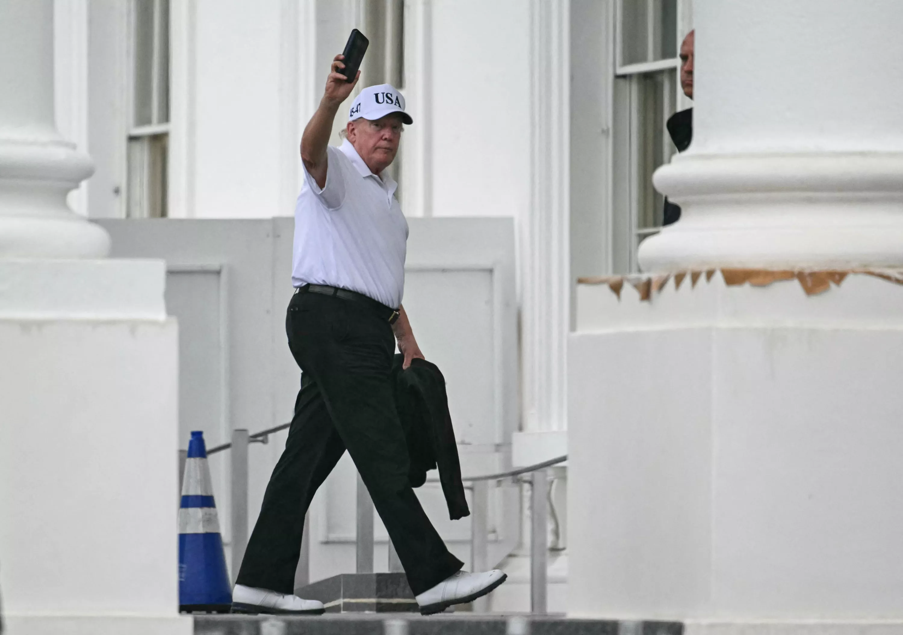 A 'heavily armed' man was detained after being seen wandering the course, with no credible threat identified, officials said