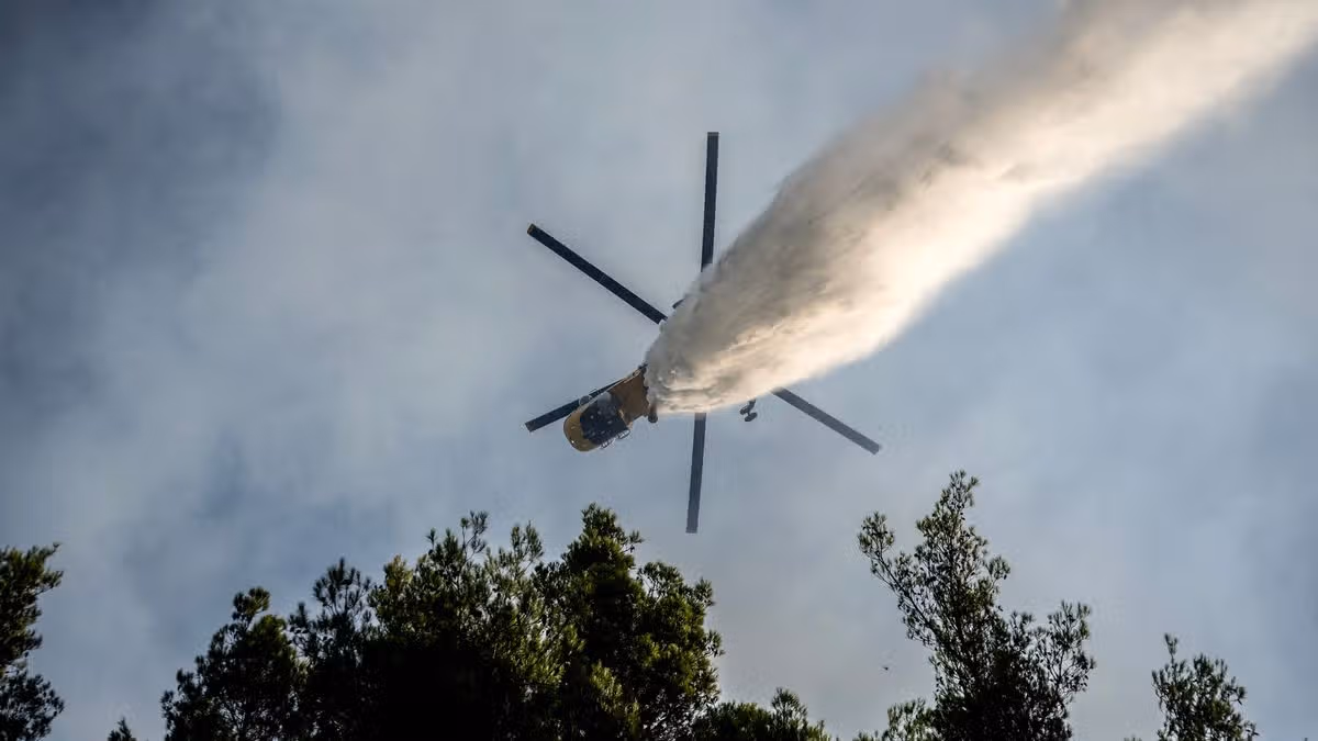 Two firefighting helicopters collided midair west of Athens on Sunday during a major wildfire operation, killing two people