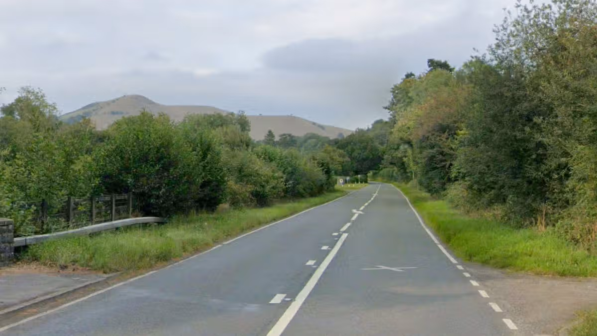Man in hospital after crash involving motorbike and van shuts road for 10 hours