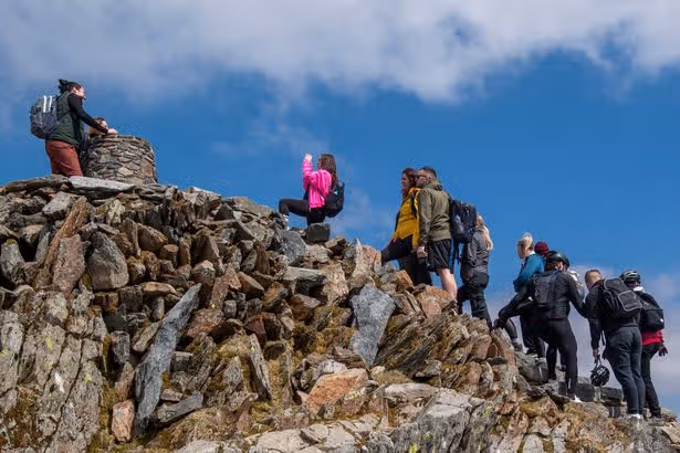 Woman climbs Yr Wyddfa but is stunned by what meets her at top of Welsh mountain