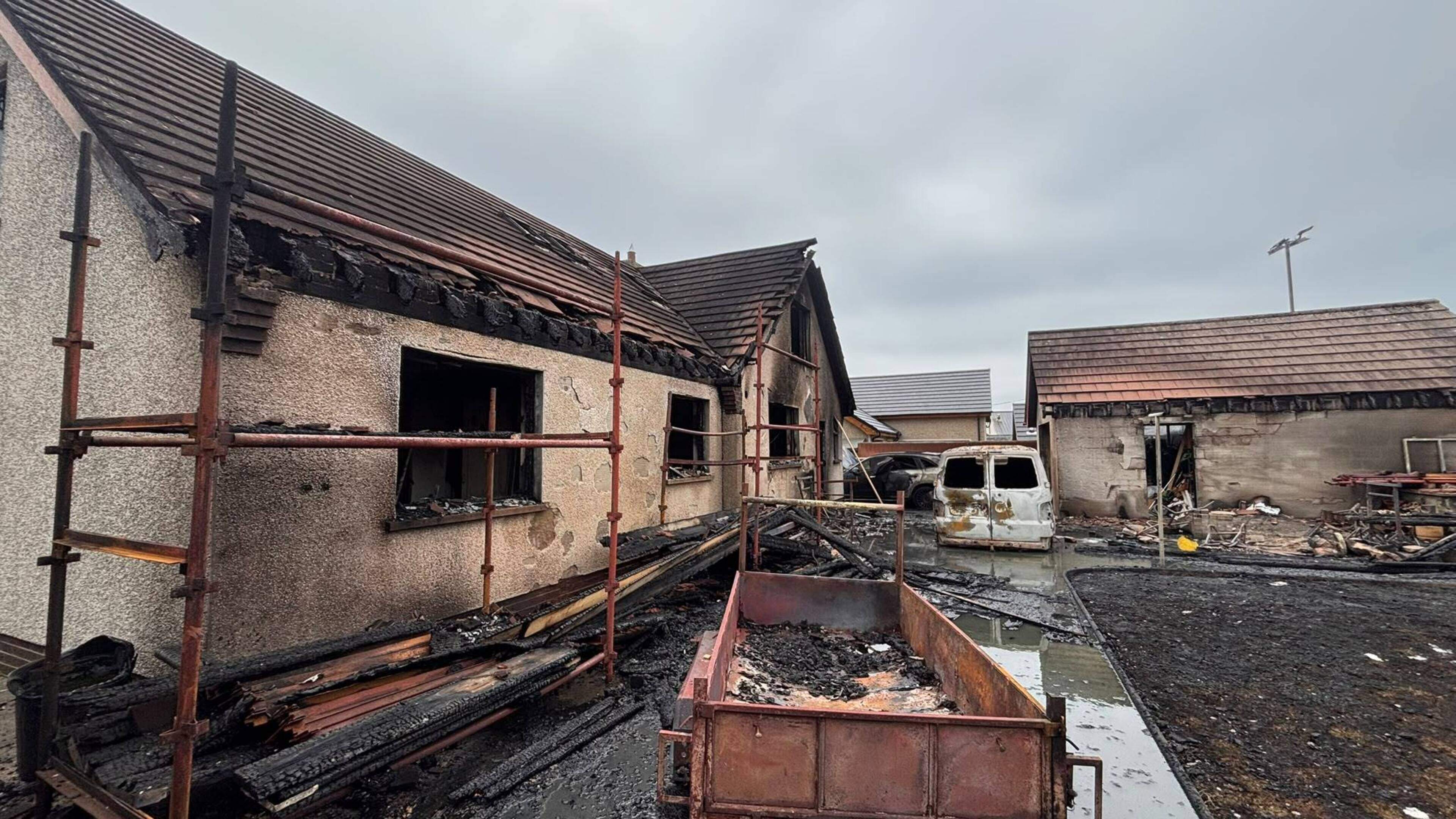 Man hospitalised as house, car and van are destroyed in overnight oil tank blaze