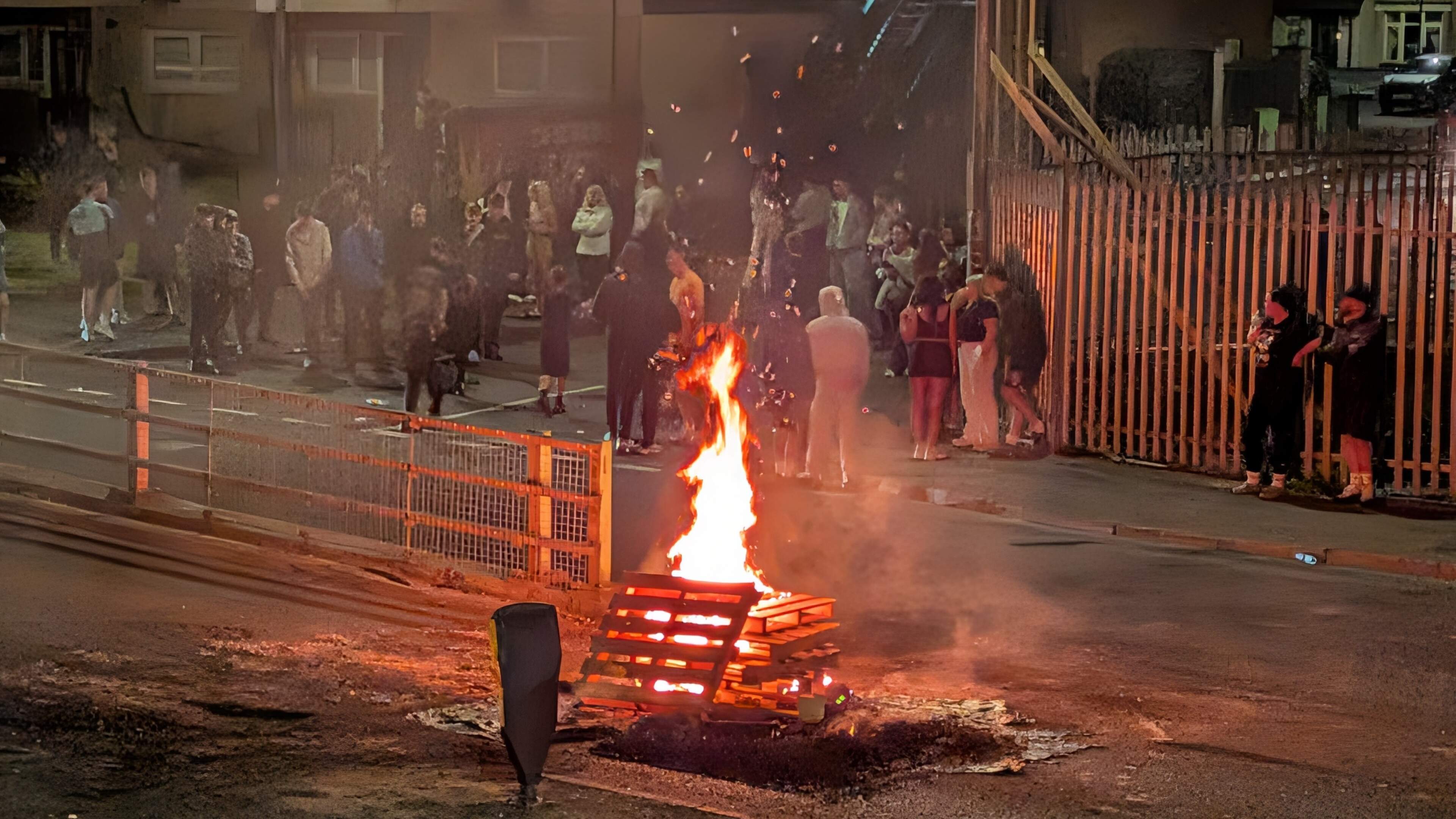 Fires lit on Bogside road as crowd gathers after removal of bonfire material
