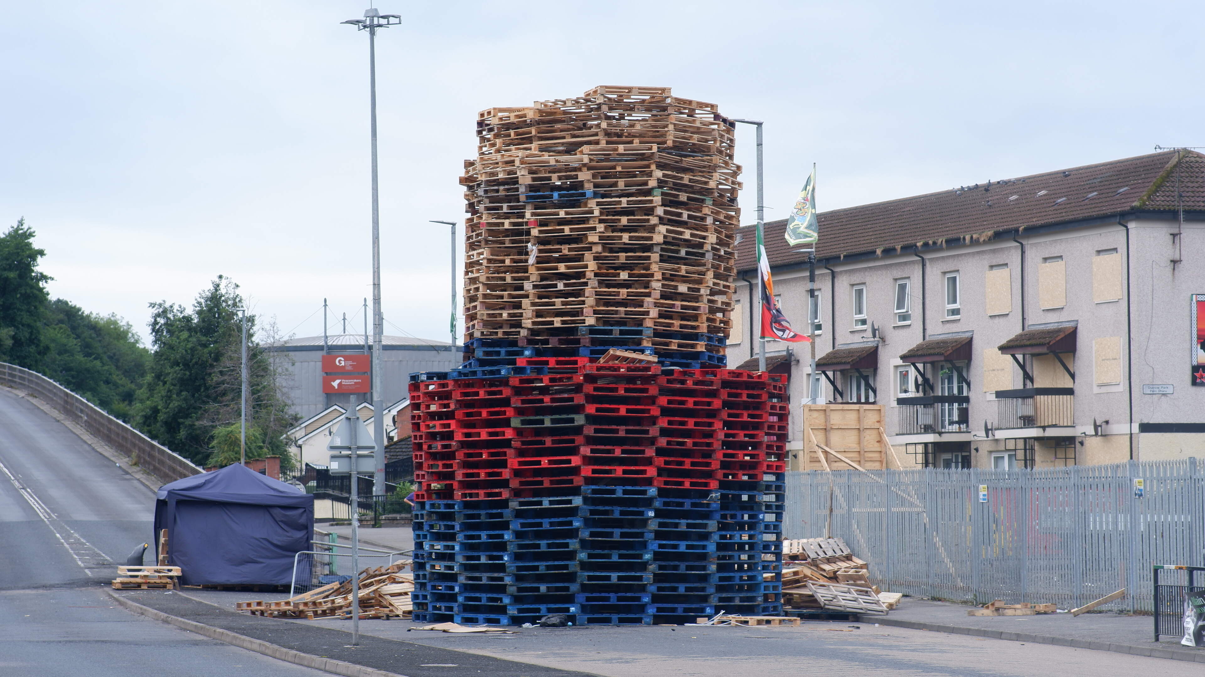 Bogside bonfire built in middle of road as windows in nearby flats are boarded up