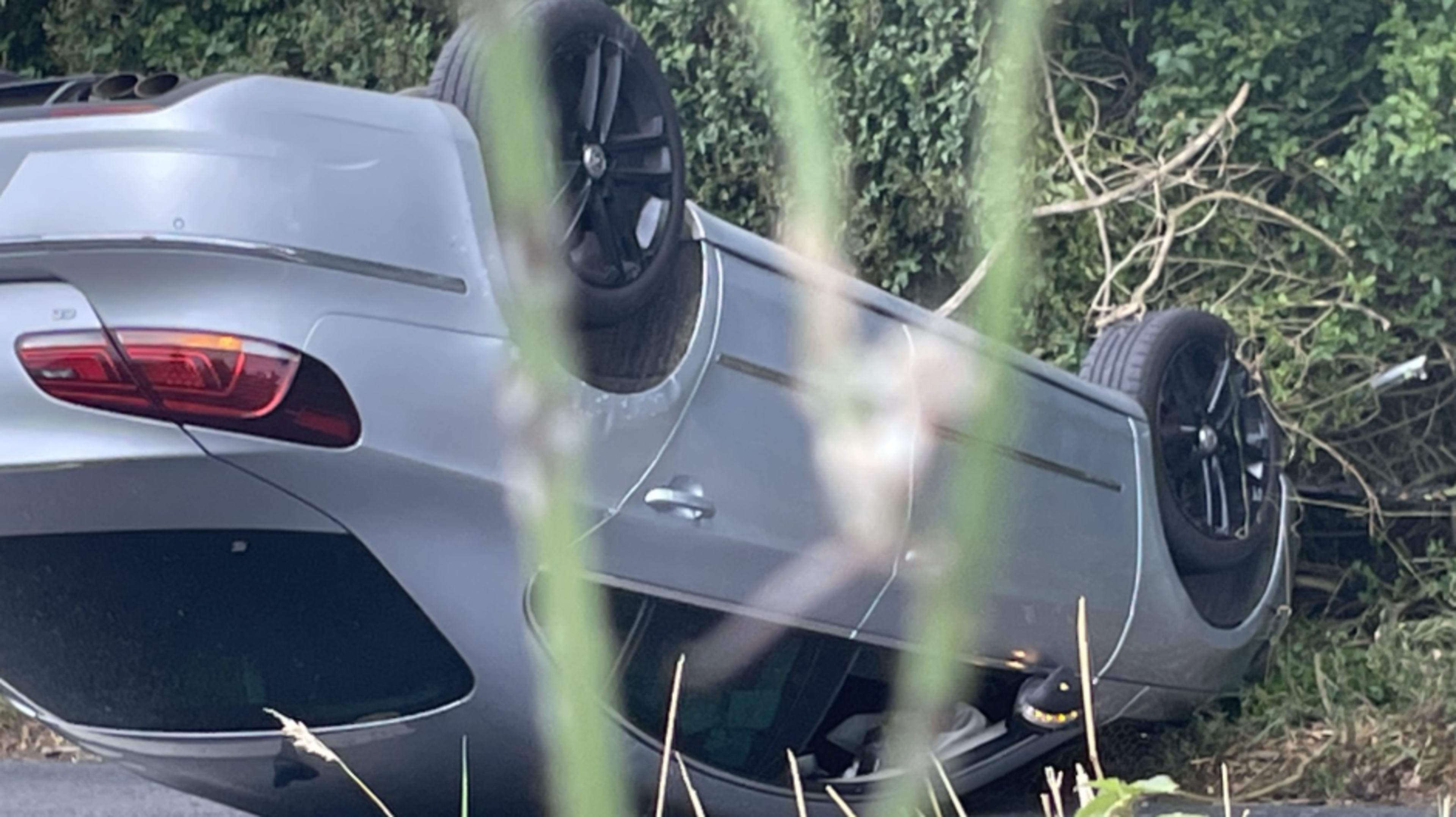 Motorist lucky to walk away from crash that left car overturned in middle of road