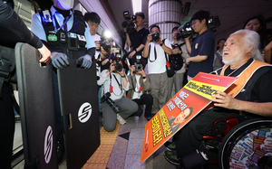 Sixty activists from the Solidarity Against Disability Discrimination occupied six train cars at City Hall Station, demanding reinstatement of 400 laid-off workers and a budget for disability rights